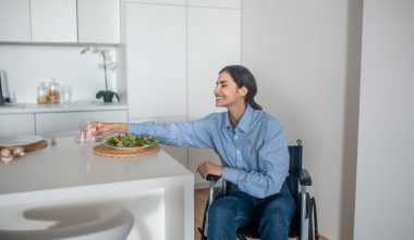 a-cute-girl-on-a-wheelchair-in-the-kitchen-at-home-2021-10-13-21-47-19-utc